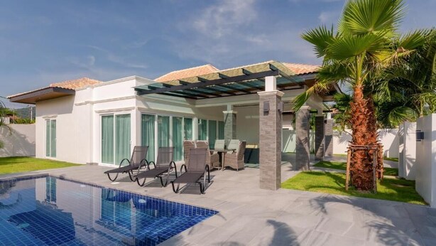 A modern house with a swimming pool, outdoor seating, and a covered patio. - Orchid Paradise Homes OPV428 (Hin Lek Fai)
