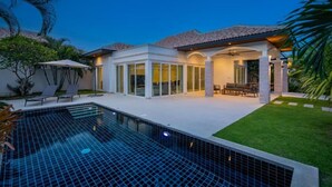 A modern house with a swimming pool, patio furniture, and a well-maintained lawn. - Orchid Paradise Homes OPV429 (Hin Lek Fai)