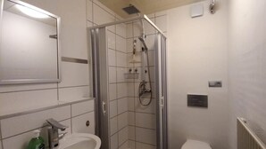 A bathroom with a shower, toilet, and sink. - Vacation apartment ELBE in Relax - Belum near Otterndorf LK Cuxhaven with pool use (Belum)