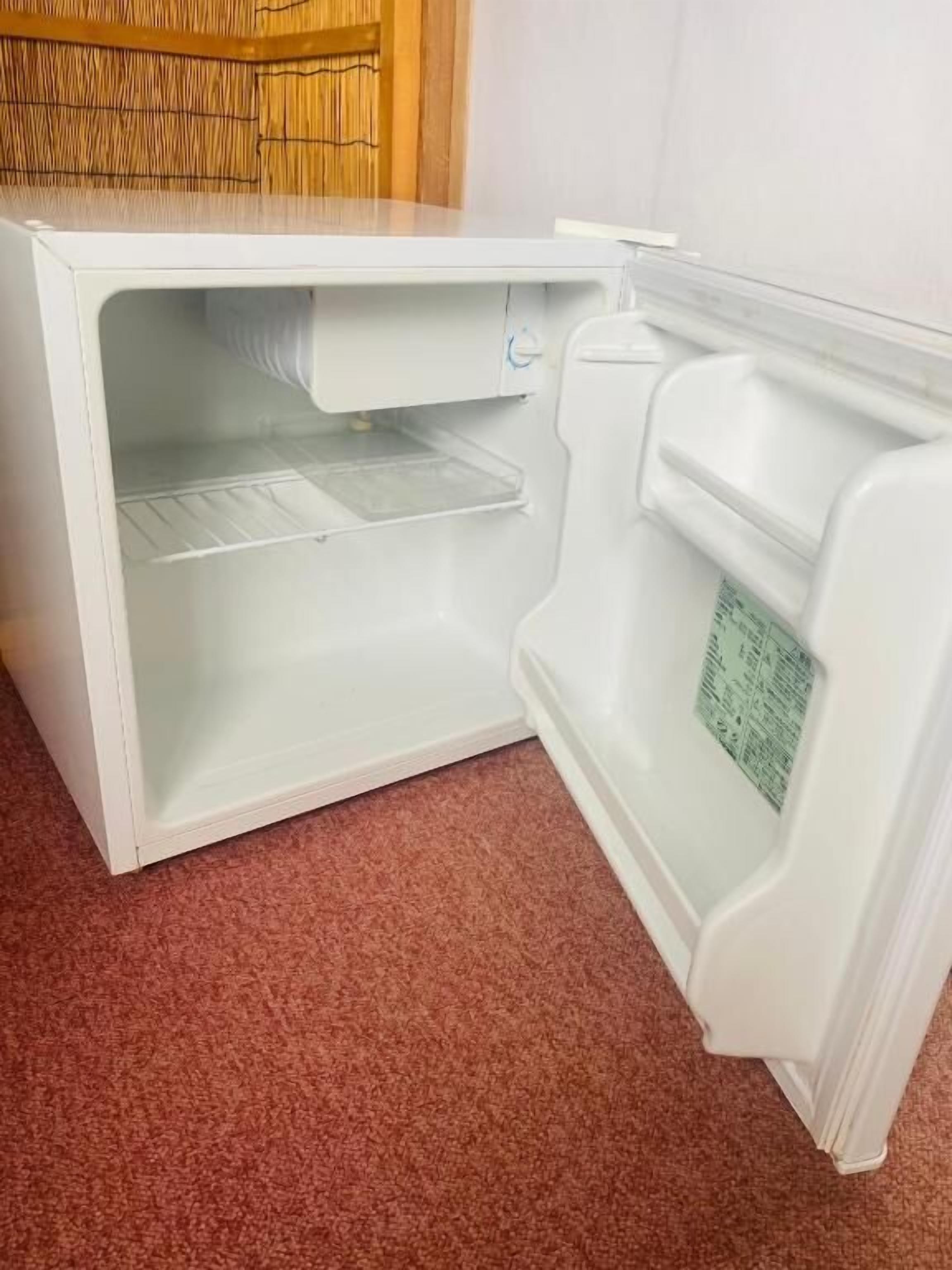Ein weißer Kühlschrank mit einem separaten Gefrierfach, einer Bedienfeld und einem Wasserspender.