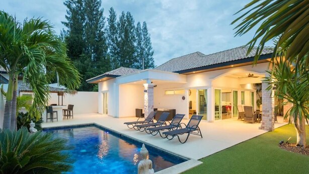A modern house with a swimming pool, outdoor seating, and a well-maintained lawn. - Orchid Paradise Homes OPV513 (Hin Lek Fai)