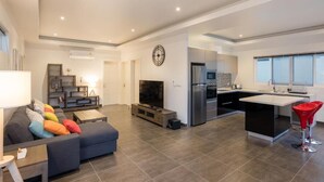 A modern apartment with a living room, kitchen, and dining area. - Orchid Paradise Homes OPV513 (Hin Lek Fai)