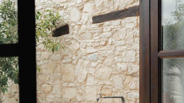 A stone wall with a built-in sink and a window. - Traditional Stone Studio Village Retreat (Potamiou)