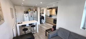 A compact kitchen with a dining area, a sofa, and a small table. - Room-delightful Double Room in Shared Ho (Chelmsford)