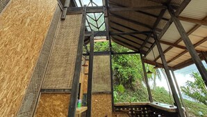 A covered outdoor seating area with a high ceiling and natural light. - Salty Cabin Sunset Views Yeh Leh Beach (Selemadeg)
