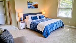 A bedroom with a bed, bedside tables, a nightstand, a window, and a door. - •LAST MINUTE DISCOUNTS• 6BR Epic Views + BBQ + Fully Stocked Kitchen• (Boone)