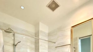 A modern bathroom with a glass-enclosed shower, a toilet, and a sink with a mirror above it. - The Boone resort (Doi Saket)