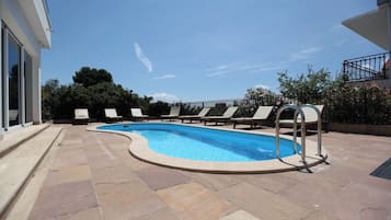 Seasonal outdoor pool, pool umbrellas, pool loungers