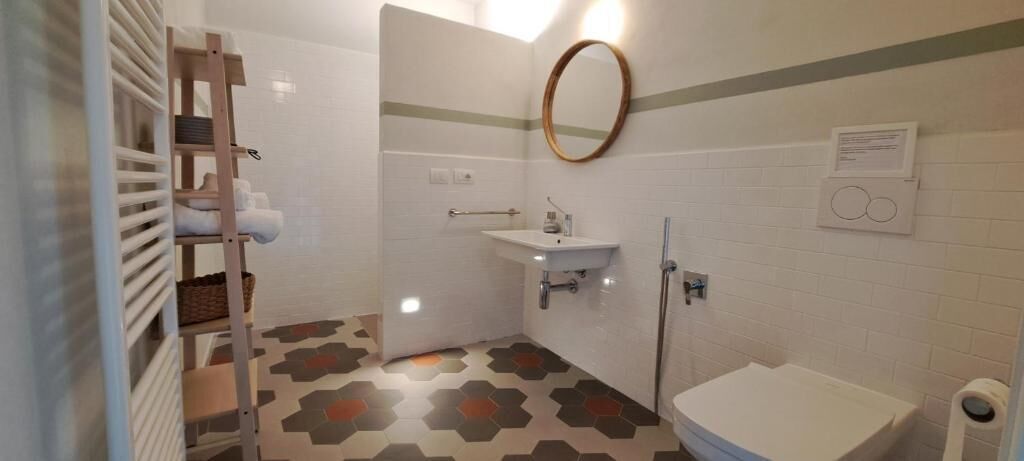 Une salle de bain équipée d’une douche, d’un lavabo, de toilettes et d’un porte-serviettes.