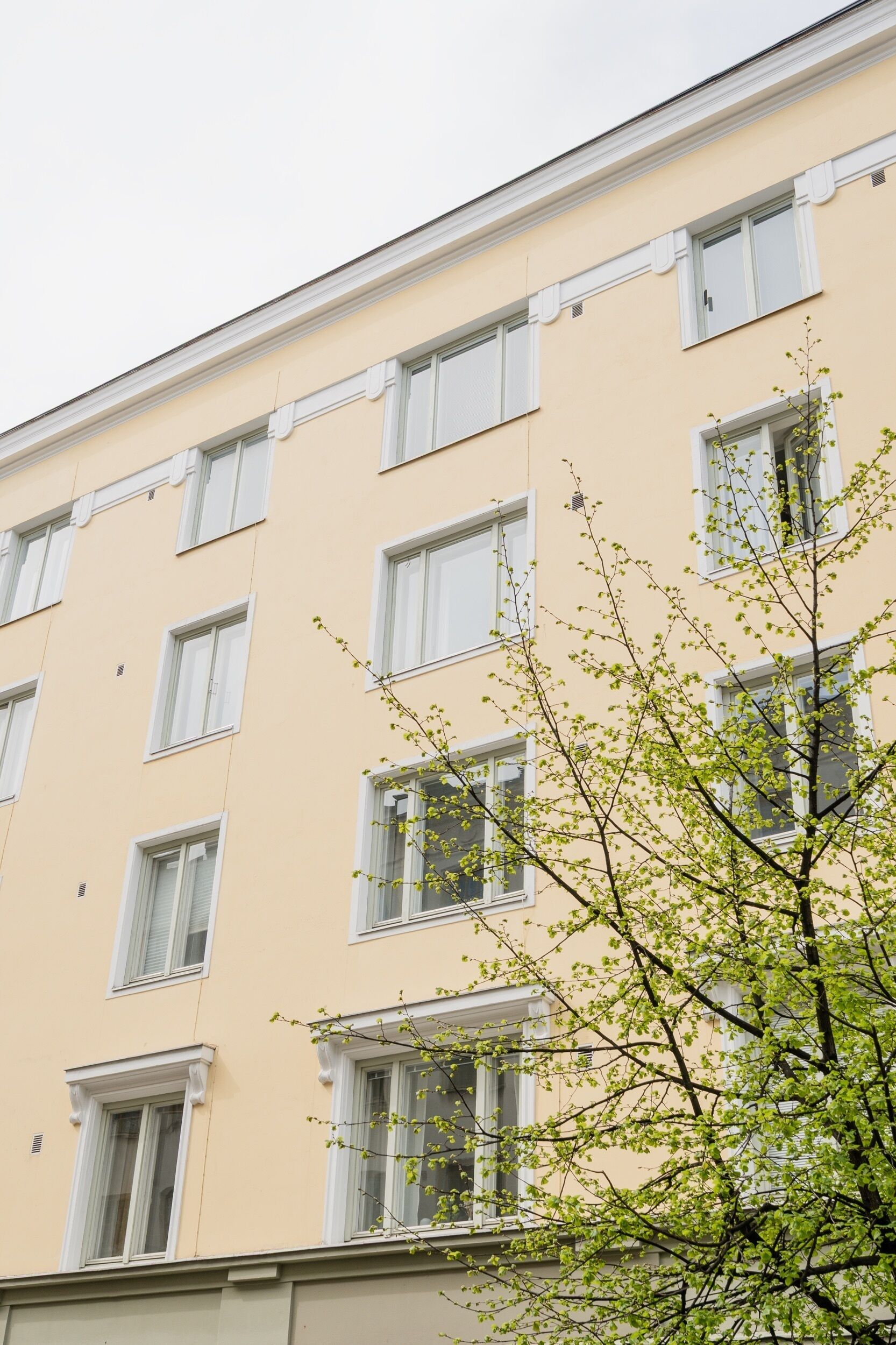 Un edificio de varios pisos con ventanas regularmente distribuidas y una fachada sencilla.