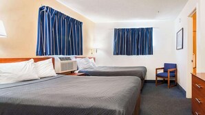 A hotel room with two beds, a chair, a dresser, and an air conditioning unit. - 2 Twin Beds|Non-Smoking (Fayetteville)