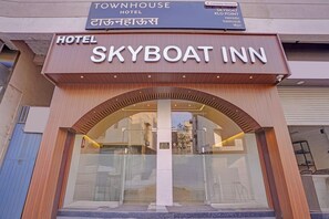 A hotel entrance with a sign reading 'SKYBOAT INN' and 'TOWNHOUSE HOTEL'. - Townhouse Skyboat XLO Point (Nashik)