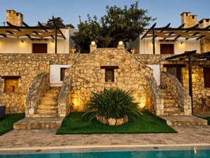 A stone building with a pool, stairs, and a well-lit entrance. - Hidden Oasis Amazing Seaview - Kalisti 1BD 1BA 4PL (Kokkino Chorio city)