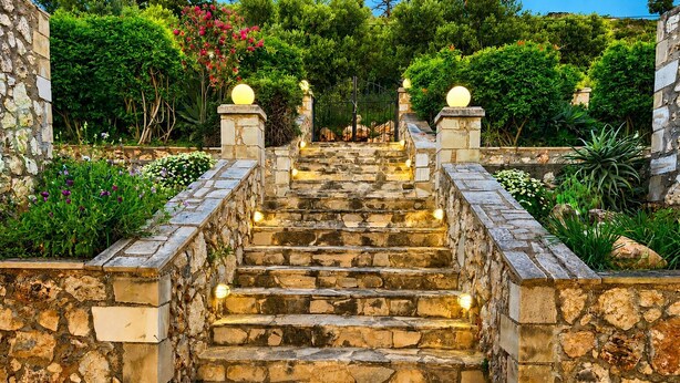 A stone staircase with steps leading upwards, surrounded by greenery and stone walls. - Hidden Oasis Amazing Seaview - Kalisti 1BD 1BA 4PL (Kokkino Chorio city)