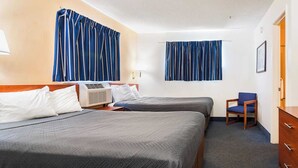 A hotel room with two beds, a chair, a dresser, and a window with curtains. - 2 Queen Beds|Suite, Nsmk,Kitchen (Fayetteville)