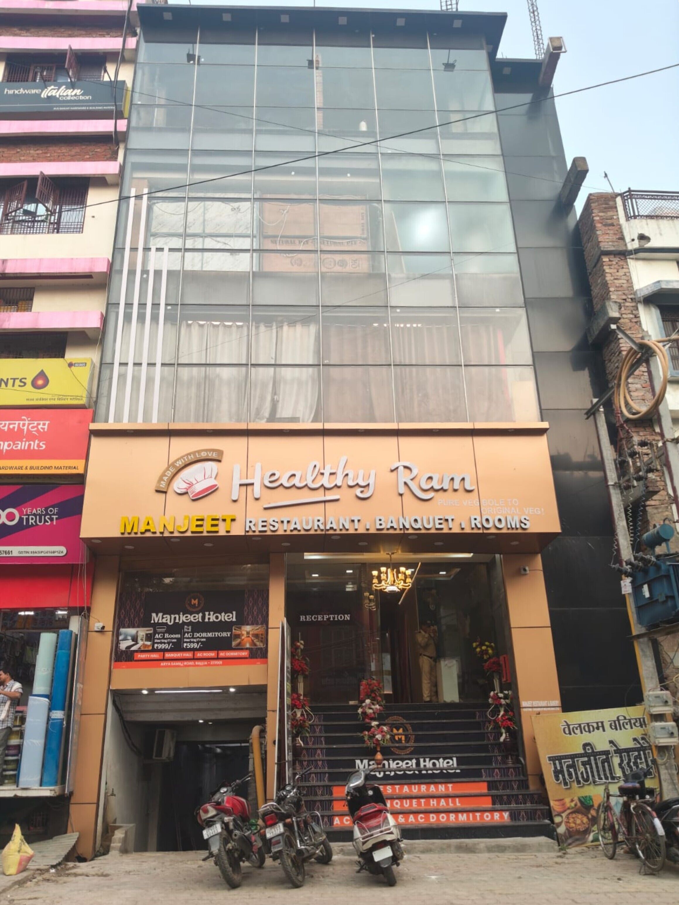 Un edificio de varios pisos con un restaurante llamado 'Healthy Ram' en la planta baja.