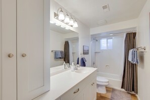 A bathroom with a white vanity, a large mirror, a shower, and a toilet. - Gateway to Zion NP! Group Getaway w/ Mtn Views (Enoch)