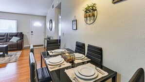 A dining area with a black table set for four, surrounded by black chairs. - Walk to Lake Ariana Park! Home w/ Screened Porch (Auburndale)