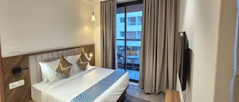 Desk, iron/ironing board, bed sheets