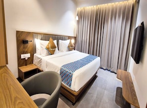 Desk, iron/ironing board, bed sheets