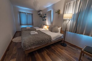 Ein Schlafzimmer mit einem hölzernen Bett, einer Stehlampe und einem Nachttisch.
