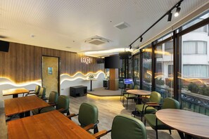 A modern conference room with a stage, large windows, and a visible 'HOP' sign. - 3A Hometel Hanoi (Ha Noi)