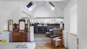 A bedroom with a bed, a dresser, a chair, and a bathroom visible through an open door. - Holiday Home 'Maison Bringwiller Plage 200m' with Private Pool and Terrace (Trégastel)