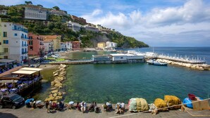 A coastal town with buildings, a pier, and clear water. - Casa Apreda in the Heart of Sorrento, Steps from the Sea (Sorrento)