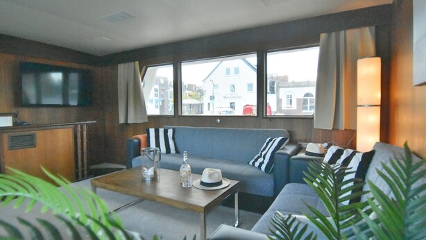 A modern interior with a sofa, a table, and a TV.
