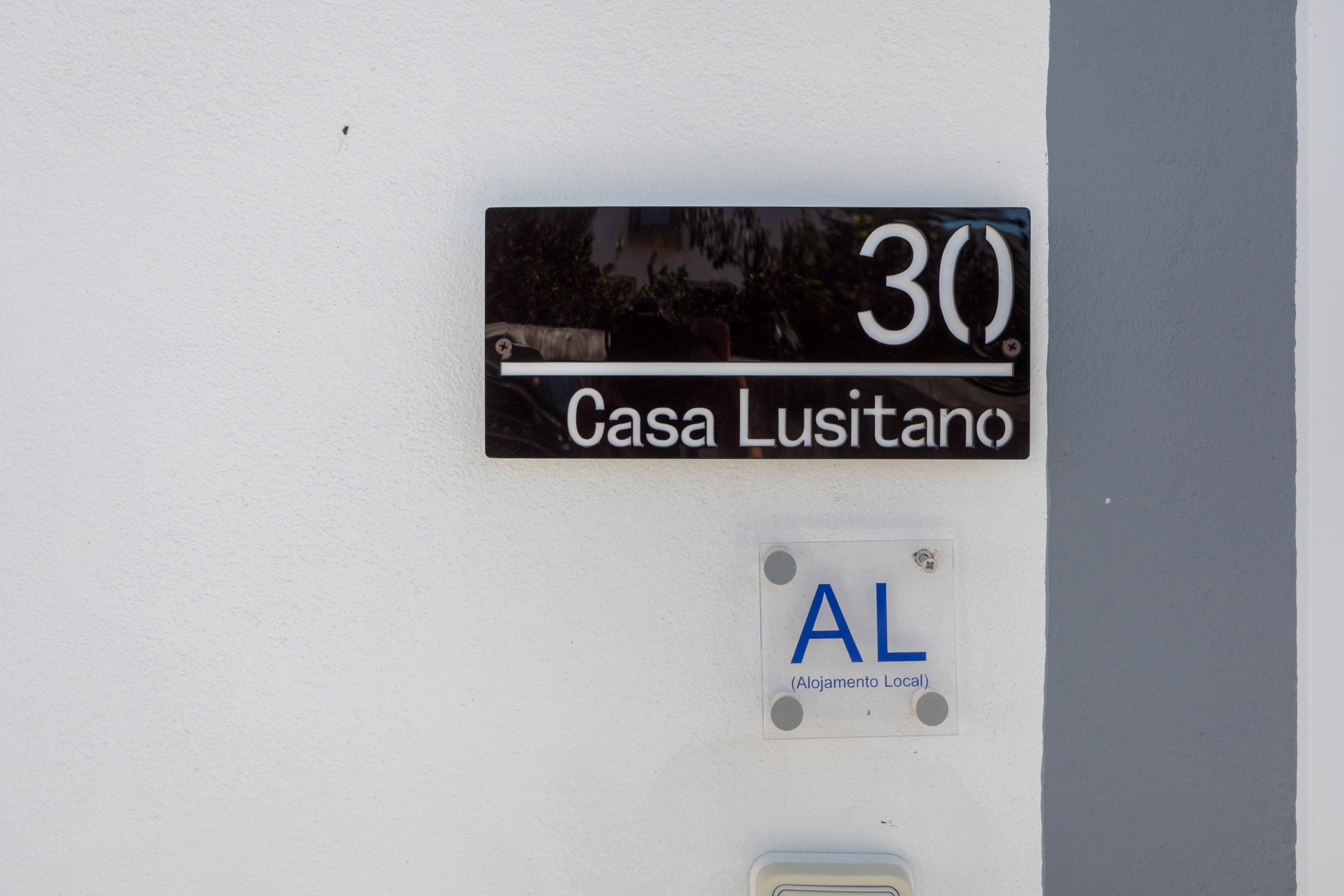 A house number sign with '30' and 'Casa Lusitano' indicating the address.