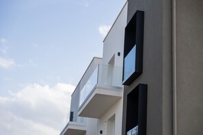 Um edifício moderno com varandas e grandes janelas.