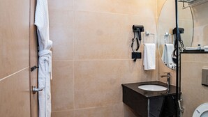 A modern bathroom with a sink, towel rack, and a mirror. - Grand Ambassador Business Hotel (Kathmandu)