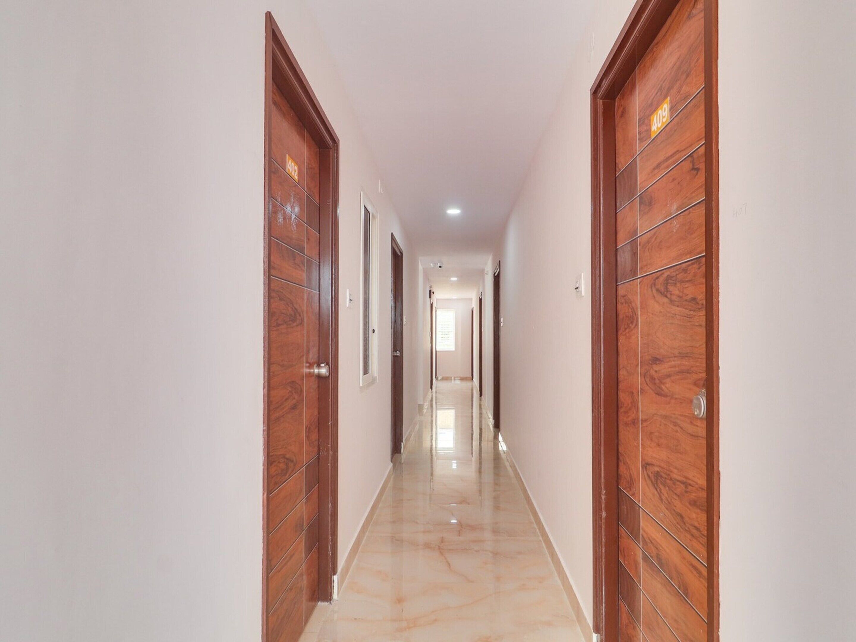 A hallway with wooden doors, each marked with a number.