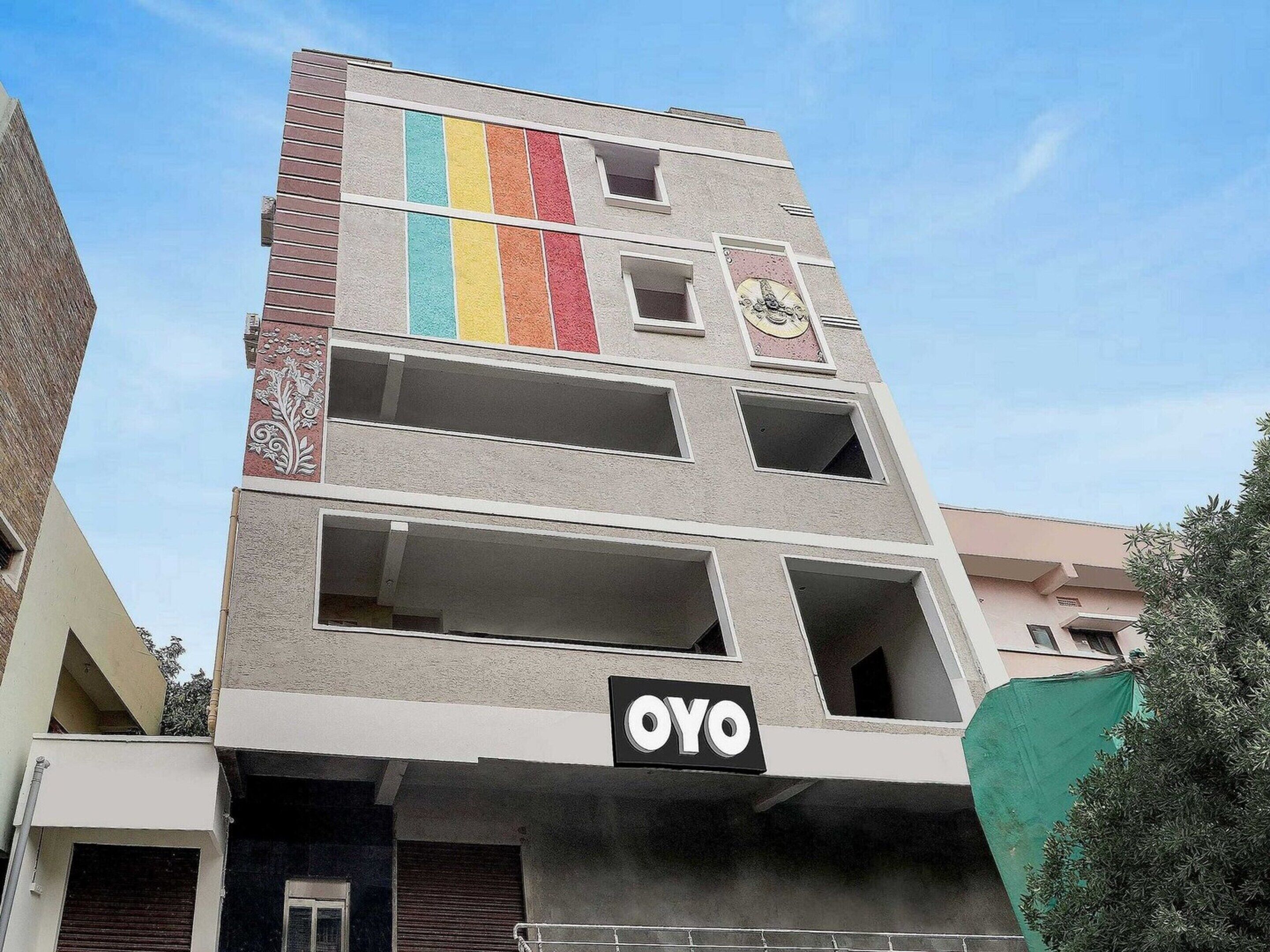 A multi-story building with a sign reading 'OYO' on the ground floor.