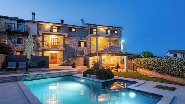 A two-story house with a swimming pool, stone facade, and outdoor seating area. - Holiday house with pool for 10 persons, 2 separate accommodation units,in Porec (Dračevac)