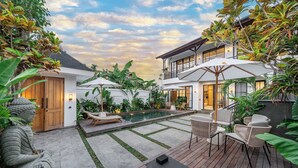 A modern house with a swimming pool, outdoor furniture, and lush greenery. - Stella - Luxury Gateaway Villa  (Sayan)