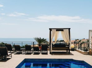 A rooftop pool area with a view of the sea, a canopy, and lounge chairs. - Residence Apartment Marghareta No. 2 (Dubrovnik)