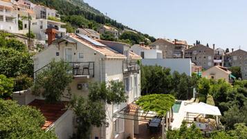 A residential area with houses, a balcony, and a pool.