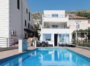 A modern two-story building with a swimming pool, outdoor seating, and a view of the surrounding landscape. - Residence Apartment Marghareta No. 1 With Sea View (Dubrovnik)