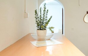 A wooden table with a potted plant and a glass bowl. - 1 bedroom amazing home in Pupnat (Pupnat)