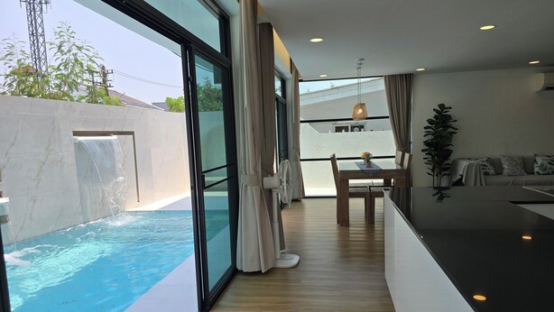 A modern interior with a pool, a dining area, and a living space. - Gorgeous 4-bedroom house with AC in charming Chiang Mai (Chang Wat Chiang Mai)