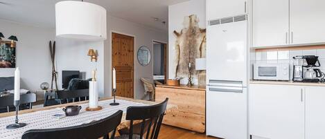 A modern kitchen with white cabinets, a microwave, and a coffee maker.