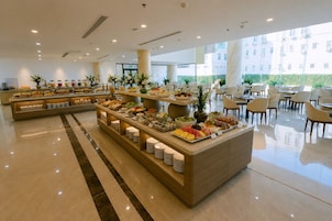 A buffet area with a variety of food items and seating arrangements.