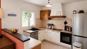 A modern kitchen with a dishwasher, oven, and a refrigerator. - 3 bedroom amazing home in Saint-Yvi (Saint-Yvi)