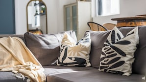 A gray sofa with patterned cushions and a yellow throw blanket. - Compact Studios in Dudley (Dudley)