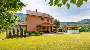 A two-story house with a patio, a barbecue area, and a small pool. - 3 bedroom beautiful home in Jasenak (Jasenak)