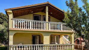 A two-story building with a balcony, a chimney, and a small garden area. - Awesome apartment in Medulin with WiFi (Medulin)