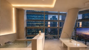 A modern interior with a large window, a bathtub, and a flat-screen TV. - UH Suite Seoul Insadong (Seoul)
