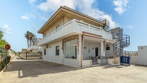 A two-story building with a balcony, a staircase, and a gated entrance. - 2 bedroom lovely home in Santa Maria del Focall (Santa Maria del Focall)