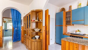 A kitchen with wooden cabinets, a built-in oven, and a tiled backsplash. - 2 bedroom lovely home in Santa Maria del Focall (Santa Maria del Focall)